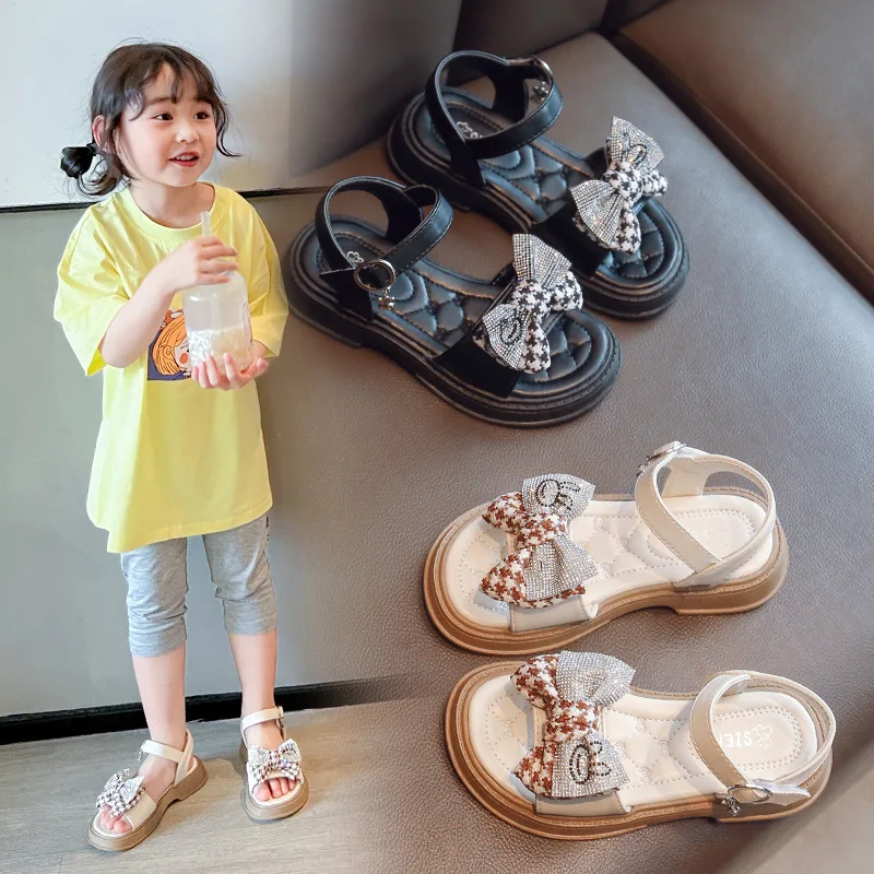 Сандалии для девочек Корейская версия, Обувь принцессы с мягким дном и бантом, Лето 2023, Новый стиль, Модные Детские сандалии для маленьких девочек . ' - ' . 1